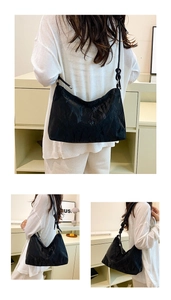 Detail of black pleated texture shoulder bag with decorative knotted rope straps