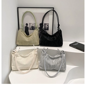 Detailed view of hobo shoulder bags in four colors with pleated texture and knotted straps