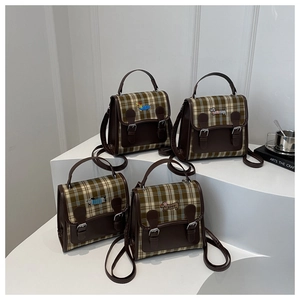 Détails du motif à carreaux vintage et broderie de teckel sur le sac à dos en cuir