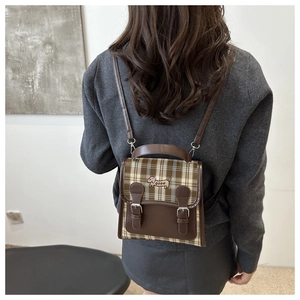 Detail of vintage plaid mini backpack with leather flap and dachshund embroidery