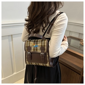 Detail of vintage plaid mini backpack with colorful dachshund embroidery and faux leather