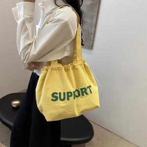 Japanese style yellow canvas tote bag with green Support lettering and drawstring closure