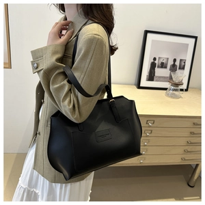 Classic black leather tote bag with lychee texture and embossed logo for women