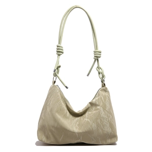 Large beige pleated shoulder bag with long knotted straps in a minimalist french style