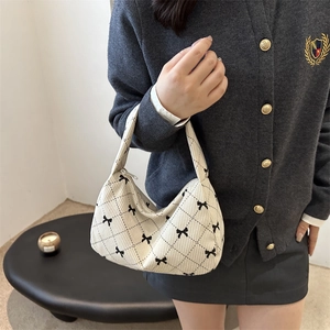 Chic beige corduroy underarm bag with black bow prints and diamond quilting design