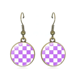 Detail of round checkered drop earrings with purple and white pattern and bronze hook