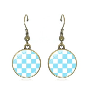 Macro detail of blue and white checkered drop earrings with antique bronze metal hooks