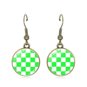 Vintage bronze checkered earrings with green and white round disc pendants on white backdrop