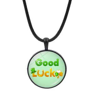 Close-up of Good Luck pendant with green shamrock and horseshoe symbols on black cord