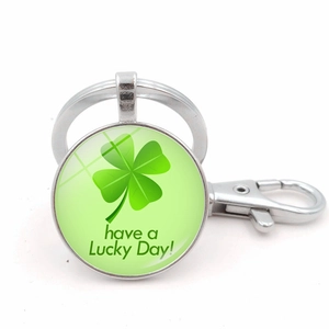 Detail of metal four leaf clover keychain with Good Luck message and lobster clasp