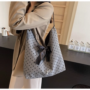 Polka dot canvas tote bag with black heart prints and a decorative silk bow accent