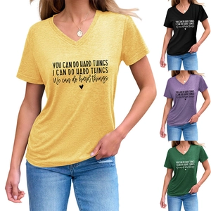 Detail view of V-neck cotton T-shirts in multiple colors with inspirational slogan