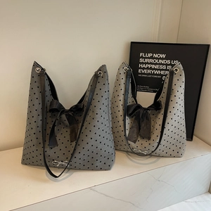 Chic grey knit tote bag with black heart patterns and oversized decorative bow detail