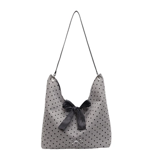 Grey heart print tote bag with black bow and silver metallic charm in a 45-degree view