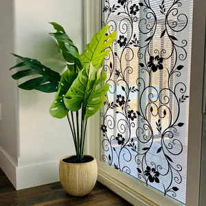Static cling window film with black floral vine patterns on a glass pane in a room
