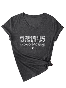 Detail of V-neck charcoal grey T-shirt featuring inspirational quote and front knot hem