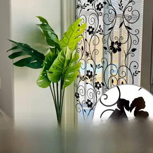Detail of static cling window film with black floral vine pattern and double-sided view
