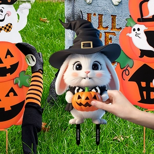 Macro detail of Halloween bunny garden stake featuring wizard outfit and pumpkin lamp