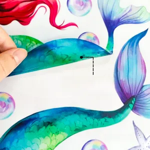 Detail of double-sided mermaid glass sticker showing colorful patterns on both sides