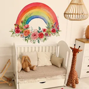 Watercolor rainbow wall decal with floral accents and green leaves for nursery decoration