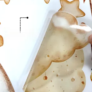Close-up of peeling a self-adhesive teddy bear and balloon wall sticker from backing