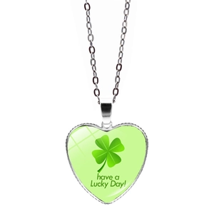 Detail shot of heart pendant with green clover pattern and have a Lucky Day engraving