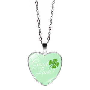 Silver-colored heart necklace with green four-leaf clover and Good Luck text