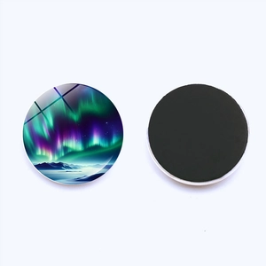 Close-up of a round crystal glass fridge magnet showing aurora design and magnetic back