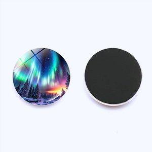 Front and back view of a circular crystal glass fridge magnet with aurora forest landscape