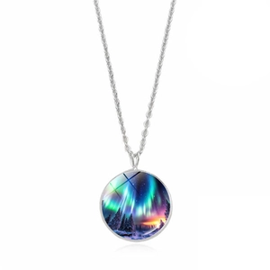 Detail of silver necklace featuring a circular pendant with Aurora Borealis winter scenery