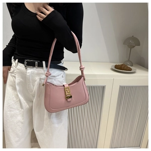 Detail of pink faux leather bag featuring a vintage Greek fret pattern metal buckle