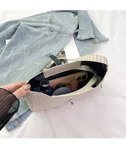 Top view of cream croc-embossed shoulder bag interior showing daily storage capacity