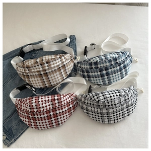 Detail showing four plaid tweed waist bags in brown, blue, red and grey on denim jeans