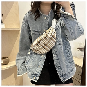Model wearing a retro plaid waist bag with adjustable strap in a cozy indoor setting