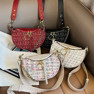 Fashionable tweed saddle bag for women featuring premium leather trim and metal hardware