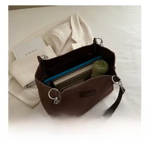 Spacious brown tote bag showing internal storage for tablets, wallets and umbrellas