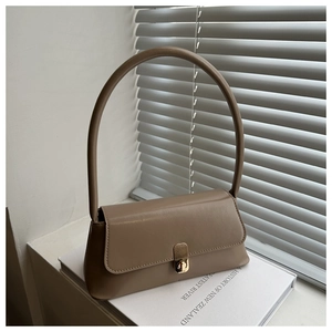 Close-up of taupe faux leather shoulder bag with golden square metal rotating clasp detail