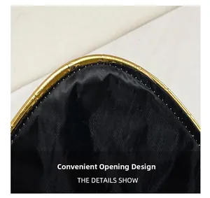 Detail of black fabric envelope bag showing its convenient magnetic closure and gold trim