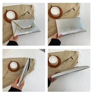 Detailed views of silver crocodile texture envelope clutch bag with gold metal clasp