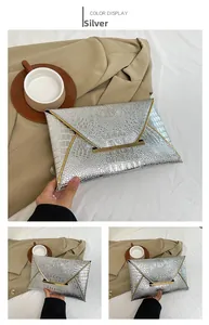 Silver envelope clutch bag with glossy crocodile texture and gold metallic trim detail