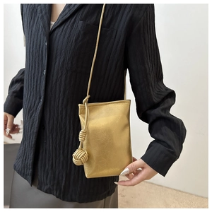 Minimalist gold metallic mini crossbody phone bag with stylish knotted shoulder strap