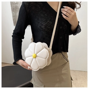 Chic white daisy shaped crossbody bag with yellow center and quilted floral petals
