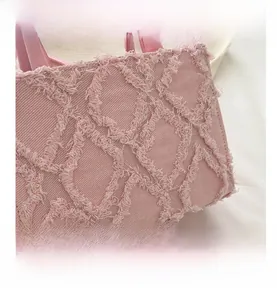 Detailed view of pink quilted denim handbag featuring unique frayed texture and stitching