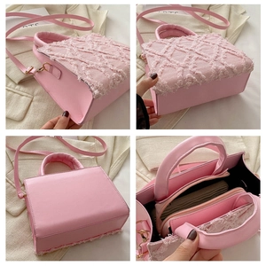 Detail view of pink quilted denim bag showing interior layers and textured material