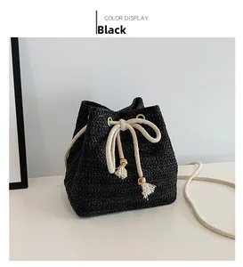 Detail of black woven bucket bag showing textured fiber pattern and cotton drawstring