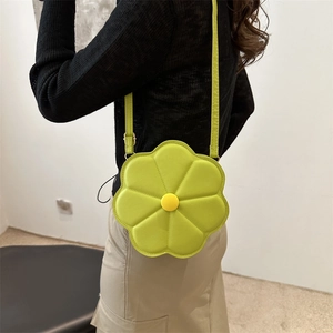 Chic lime green floral crossbody bag with quilted petals and adjustable shoulder strap