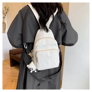 White pleated chest bag for women with cute bear pendant and multi-pocket design