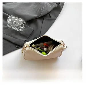 Interior view of off-white leather bag showing capacity for lipstick and makeup