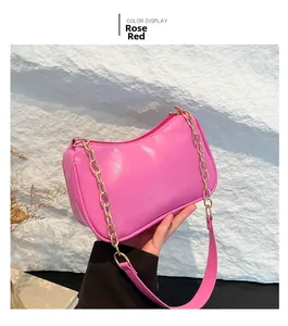 Detail of rose red shoulder bag featuring gold chain strap and smooth PU texture