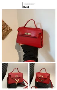 Detail of red crocodile texture small square handbag with gold rotating metal lock